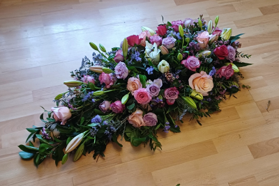 Funeral Casket Spray - A casket spray full with abundance blooms including lilies roses