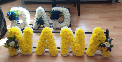 Lettering - Based Lettering chrysanthemums, various colours with matching corsage and ribbon.
 please gave 3 days notice.
