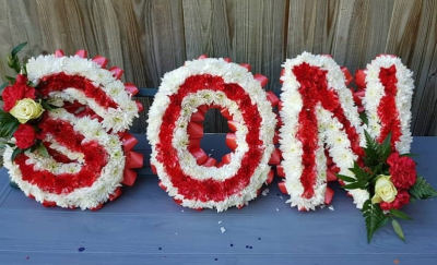 Red & White Letter Tribute - Red & White Letter Tribute – A personalised funeral letter arrangement made with red and white flowers. Bold, traditional and deeply meaningful.