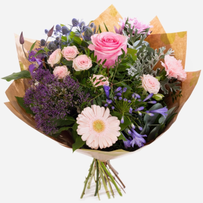 Lavender Kiss - Lavender Kiss is an elegant bouquet of soft pink and lilac blooms with lush green foliage.