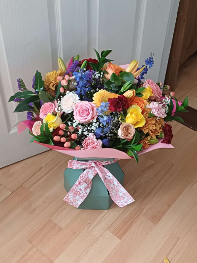 Bright Summer - A vibrant hand-tied bouquet of fresh colourful flowers and foliage in red, purple, yellow, blue, pink, orange and white, guaranteed to brighten their day. (Large size shown in the picture)