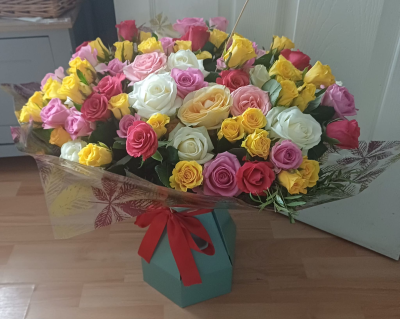 Mixed Roses Twist - A stunning arrangement of 100 mixed roses in red, pink, yellow, white and cerise. Beautifully arranged to create a vibrant, luxurious gift for any special occasion.